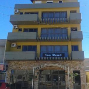 a yellow building with aoked miracle sign on it at Mirante Hotel in Santa Vitória do Palmar