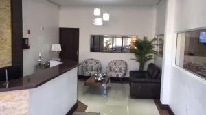 a living room with a couch and a table at Mirante Hotel in Santa Vitória do Palmar