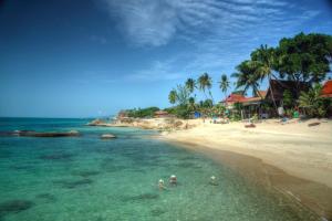 a group of people in the water on a beach at Palm View Villa in Lamai