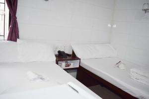 Voodi või voodid majutusasutuse Pay-Less Guesthouse (7/F A9) toas