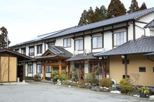 a large building with a lot of windows at Minshuku Asogen in Aso
