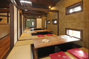 a row of tables in a room at Minshuku Asogen in Aso