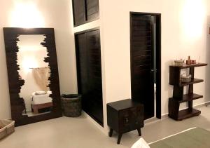 a room with black doors and a table and a mirror at Xcacel Dreams in Chemuyil