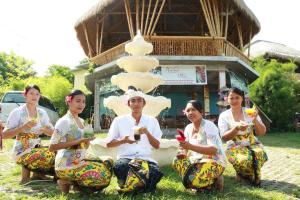 a group of people sitting in front of a cake at Pt putra momongan menyelam scuba in Amed