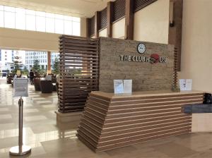 a lobby with a sign on a brick wall at Wind Residence Condo - Tagaytay by jaderooms in Tagaytay