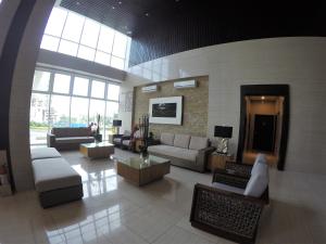 a living room with couches and tables in a building at Wind Residence Condo - Tagaytay by jaderooms in Tagaytay