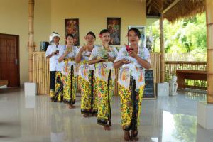 a group of women standing in a room looking at their cell phones at Pt putra momongan menyelam scuba in Amed
