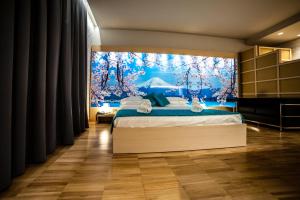 a bedroom with a bed with a large window at Hotel Terre Dei Salici in Caramagna Piemonte