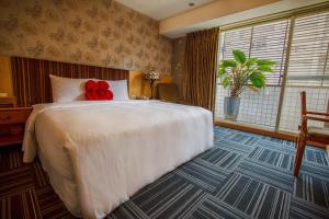 Postel nebo postele na pokoji v ubytování Cai She Hotel