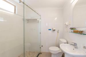 a bathroom with a shower and a toilet and a sink at Spotlight Hotel in Ho Chi Minh City +36 photos