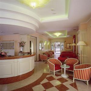 a living room with a red couch and chairs at Hotel Olivo in Arco