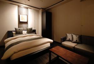 
A bed or beds in a room at AROMA GARU (Adult Only)
