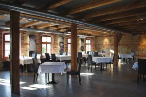 a dining room with tables and chairs and brick walls at Stary Młyn in Strzelce Opolskie