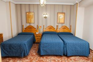 Postel nebo postele na pokoji v ubytování Hotel Guadalquivir