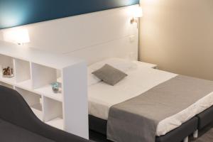 1 dormitorio con 1 cama con cabecero blanco en Residence del sole Manfredonia, en Manfredonia