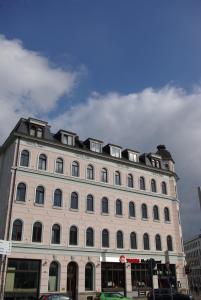 a large white building with a lot of windows at Apartments in der Friedrich Ebert Straße 90 Sportforum in Leipzig