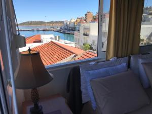 a room with a bed and a window with a view at Lary's Family in Agios Nikolaos