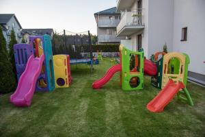 a group of playground equipment in a yard at Willa Północna in Karwia
