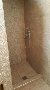 a bathroom with a shower with a tiled shower at Amalthia House in Arkasa