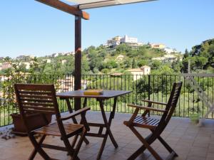 a table and two chairs on a patio with a view at Casa Le Querce in Ogliastro Cilento
