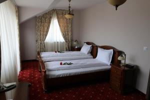 Postel nebo postele na pokoji v ubytování Hotel Slavia