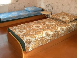 a bed with a quilt on it in a room at Albatross in Kaunata