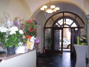 una habitación con flores en un mostrador junto a una puerta en Garni Hotel Post, en Weissenstadt