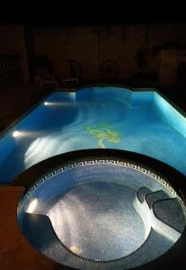 a large swimming pool in a dark room at Mood Farmhouse Mythology in Għarb