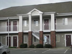 a apartment building with balconies and a parking lot at Affordable Suites Conover / Hickory in Conover