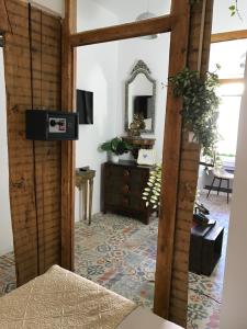 a living room with a mirror and a dresser at Alfama Patio Apartments in Lisbon