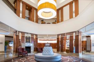 a large lobby with a fireplace and a large ceiling at Leonardo Royal Southampton Grand Harbour in Southampton +61 photos