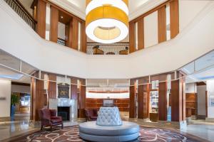 a large lobby with a fireplace and a large ceiling at Leonardo Royal Southampton Grand Harbour in Southampton