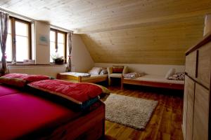 ベドジホフにあるSauna Cottage BedRichのベッドとソファ付きの屋根裏部屋
