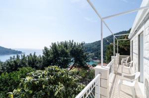 a balcony of a house with a view of the ocean at Guest House Kralj in Saplunara