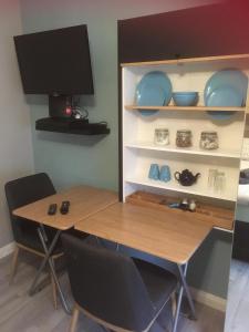 a table and chairs in a room with a tv at Lincoln Self Catering in Lincoln