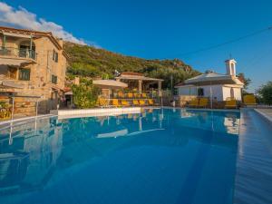 a large swimming pool in front of a building at Palataki in Kardamyli