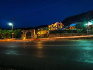 an empty street at night with a building at Palataki in Kardamyli
