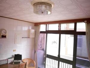 a room with a table and a chandelier and a window at 1969 - Elixir of Love in Tainan