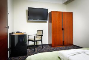 a hotel room with a bed and a desk and a tv at Meresuu Spa & Hotel in Narva-Jõesuu