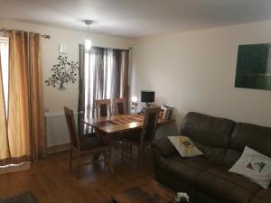 a living room with a table and a couch at Caftop Aparthotels Wenlock Manchester in Manchester