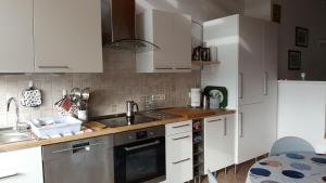 a kitchen with white cabinets and a sink at BB dänisch/deutsch in Cologne