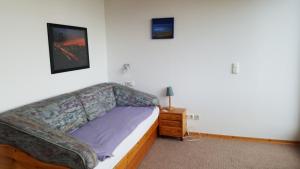 a living room with a couch and a night stand at BB dänisch/deutsch in Cologne
