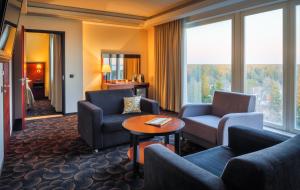 a living room with couches and a table at Meresuu Spa & Hotel in Narva-Jõesuu
