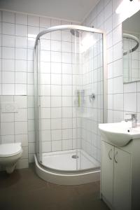 a bathroom with a shower and a toilet and a sink at City Express Hostel in Krakow