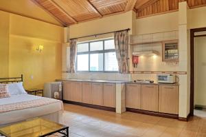 a bedroom with a bed and a kitchen at Space International Hotel in Nairobi