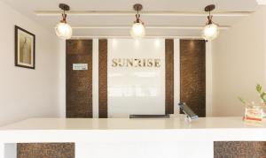 a counter in a restaurant with a sign that reads sunrise at Treebo Trend Sunrise IG Road in Chikmagalūr