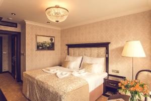 Postel nebo postele na pokoji v ubytování Hotel Florian Palace