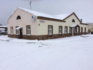 a building with snow on the ground at Westwind puhkemaja in Kunda