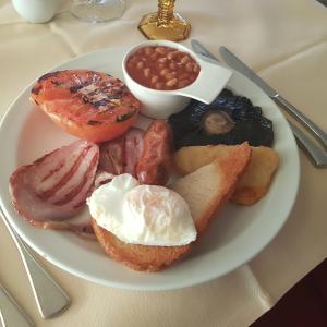 a plate of breakfast food with eggs breadnuts and beans at Prom Hotel in Great Yarmouth