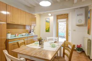 a kitchen with a wooden table and chairs in a room at Arts and Flowers in Sinalunga